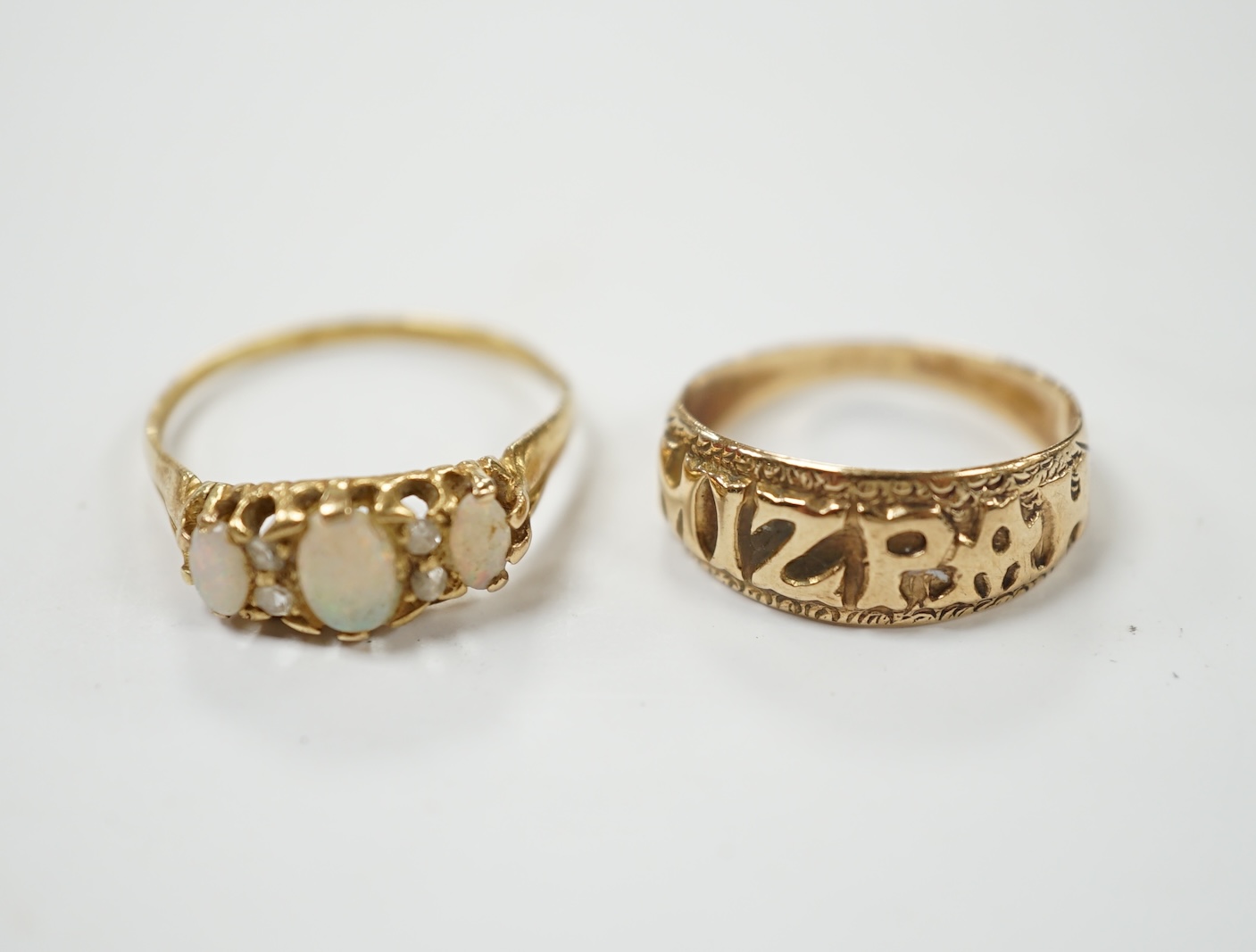 A 9ct gold 'Mizpah' ring and a yellow metal, three stone white opal set ring, with diamond chip spacers, size P, gross weight 5.2 grams. Condition - poor to fair